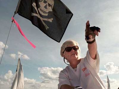 SPYC’s Helen Larsen directs her crew during a race in 1996 while flying a Jolly Roger, which she raised as a playful intimidation tactic.